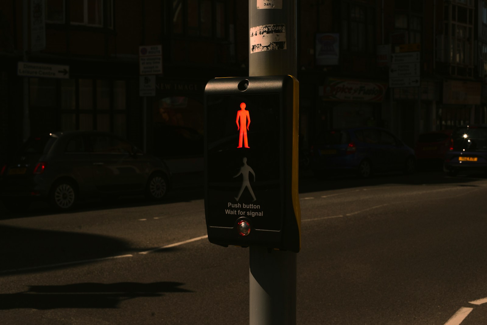 a pedestrian crossing sign on a city street