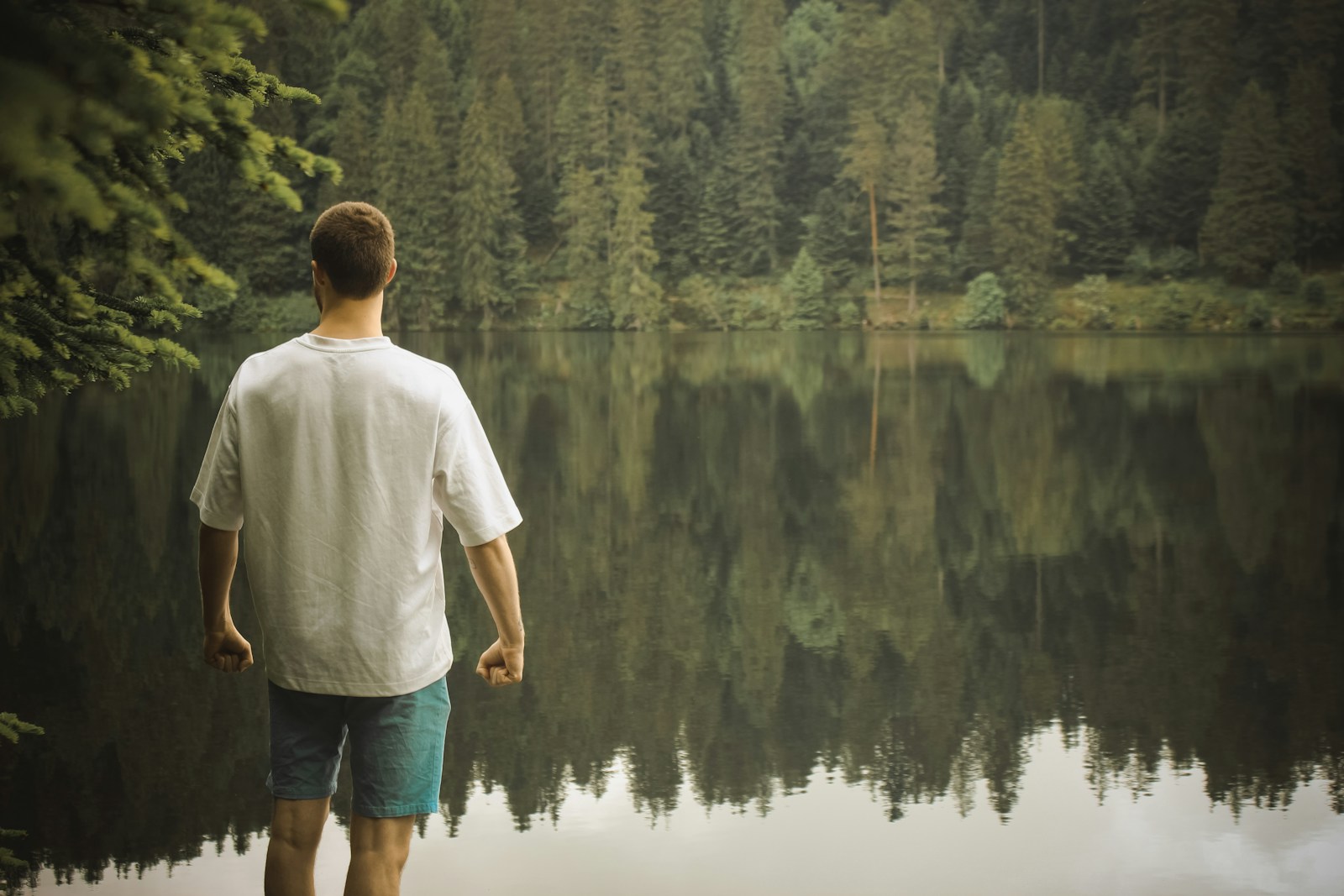 A man standing in front of a body of water